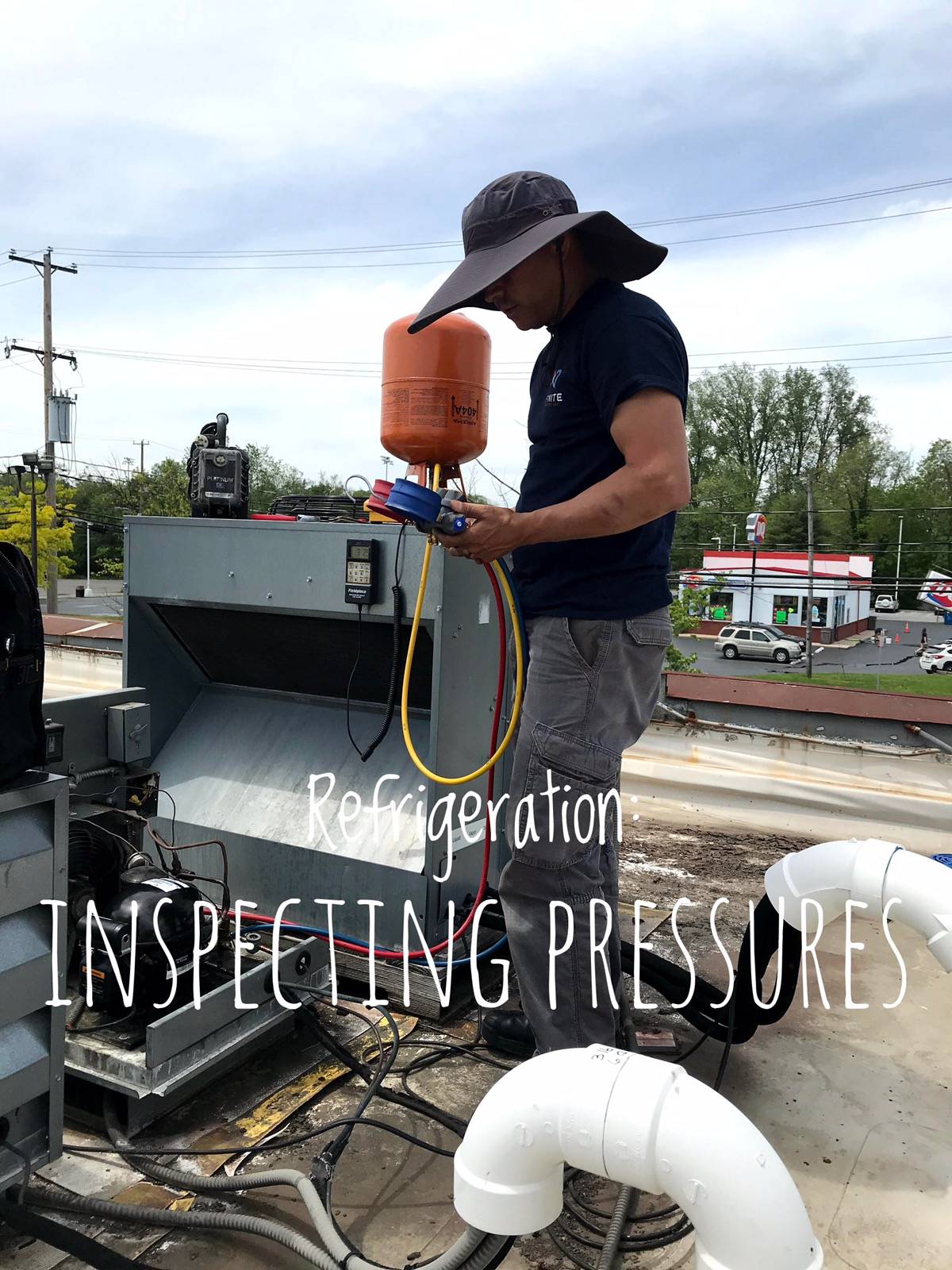 Infinite refrigeration technician inspecting pressure